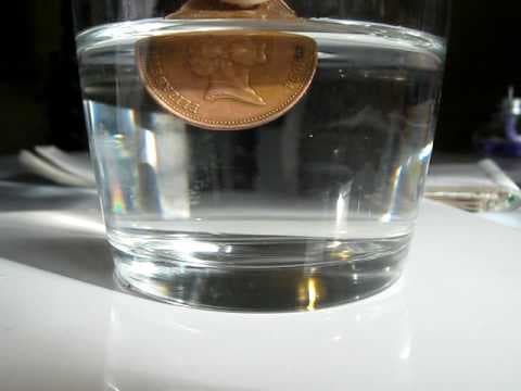 Amber cleans a copper coin with salt and vinegar