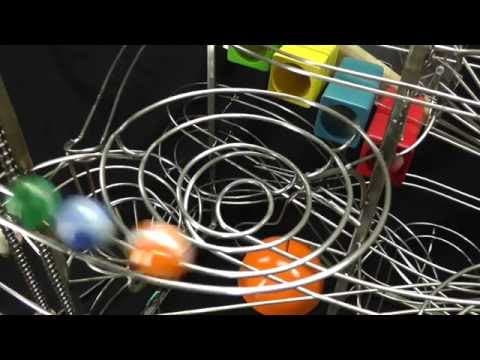 Steel track rolling ball sculptures by kinetic artist Tom Harold